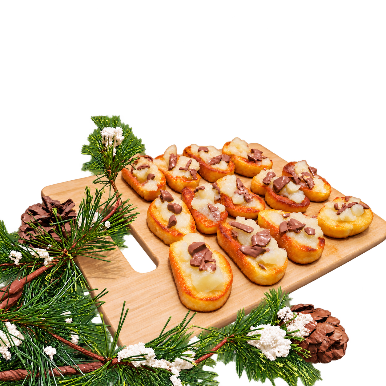 Pear and chocolate crostini arranged on a wooden serving board with festive evergreen branches, white flowers, and pinecones